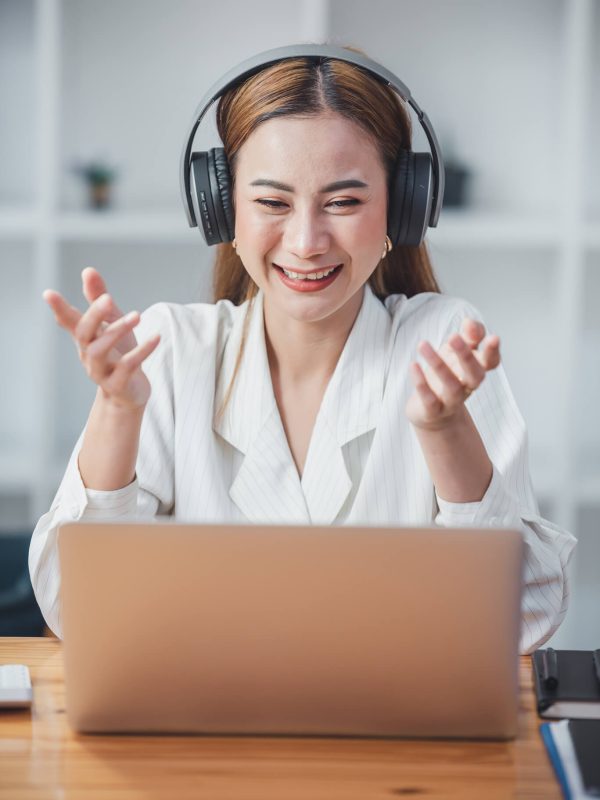 asian-girl-happy-and-charming-wear-headphones-to-communicate-by-video-conferencing-at-your-desk-usi.jpg